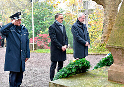 Ob Ibert steht mit Tilman Petters und Ingolf Grunwald von der Polizei in stillem Gedenken vor dem Mahnwahl für die Opfer der Kriege.