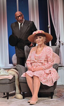 Das Foto zeigt Ron Williams (stehend) und Doris Kunstmann (auf einem Sessel sitzend)