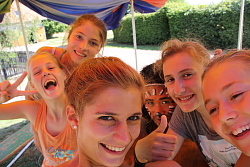 Das Bild zeigt sechs Mädchen, die ihre strahlenden Gesichter in die Kamera halten. Das Mädchen ganz links macht das Victory-Zeichen. Die Dritte von rechts hat ein geschminktes Gesicht. Die Zweite von rechts reckt den rechten Daumen hoch.