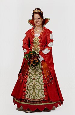 Die erste Chrysanthemenkönigin gab es 2006. Auf dem Bild ist Anita I. zu sehen. Sie trägt eine königliche Robe in Rottönen, eine goldene Krone aus stilisierten Blüten und einen Strauß aus Chrysanthemen.