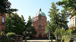 Blick von vorn auf die Christuskirche in Lahr. Ein markanter Kuppelbau aus rotem Sandstein im Stil der italienischen Renaissance.