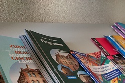 Ein Regalfach mit Flyern. 