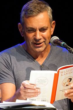 Das Foto zeigt Wladimir Kaminer wie er aus einem seiner Bücher vorliest.