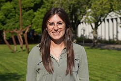 Portraitfoto von Karen Wurth. Sie hat lange braune Haare, trägt eine Brille und eine graue Bluse. im Hintergrund Bäume, Rasen und ein Teil des Bürgerbüros Rathaus 1 in Lahr.