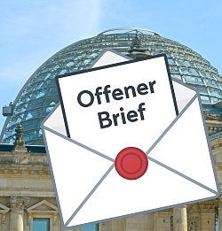 Vor der Kuppel des Bundestags zeigt sich ein Symbol mit einem offenen Briefumschlag und der Aufschrift "Offener Brief" 