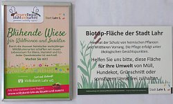 Zwei Schilder zur Kennzeichnung von Biotopen und Blühflächen, mit dem Hinweis die Flächen sauper zu halten.