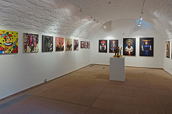 Blick in den Gewölbekeller mit verschiedenen Bildern der Ausstellung. 